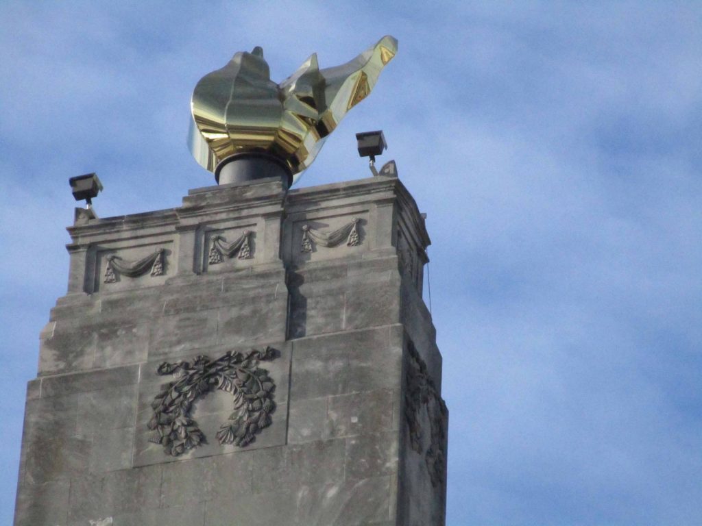 gold flame on top of Veterans Memorial Building
